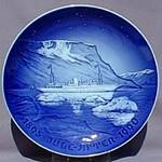 A blue and white plate with a ship in the water

Description automatically generated